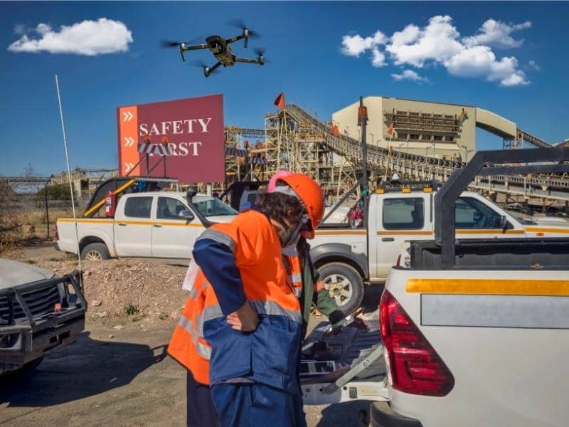 Drone survey team using aerial mapping technology to collect site data for land analysis.