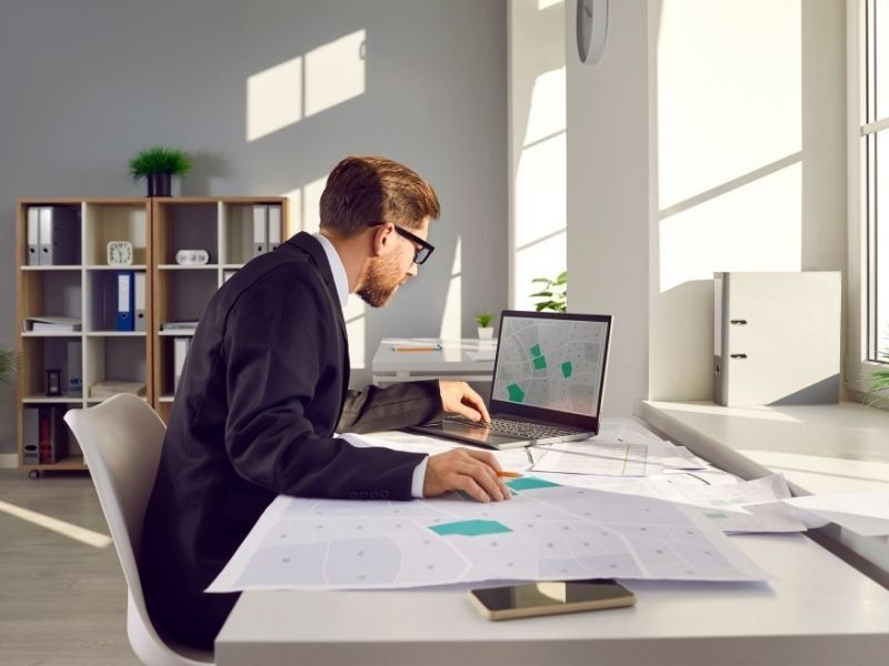 Property professional reviewing maps before making a flood risk decision